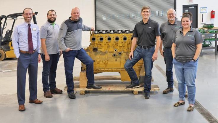 Dr. Jason Dockter, Kody Letterle, Nick Johnson, Keith Heiar, Jeff Gardner and Dr. Nancy Sweet standing by one of the donated engines.