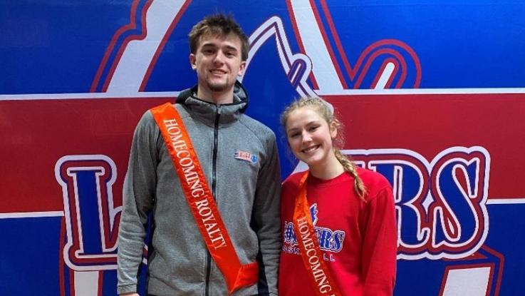 2024 Homecoming Royals Dane Foster and Olivia Marchizza. They are wearing red sashes that say "Homecoming Royalty" in gold lettering.