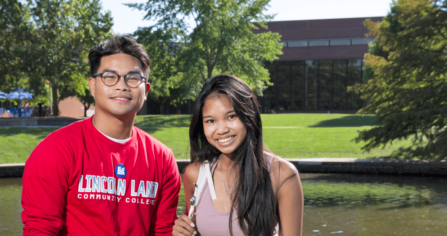 Two LLCC students by lake on campus
