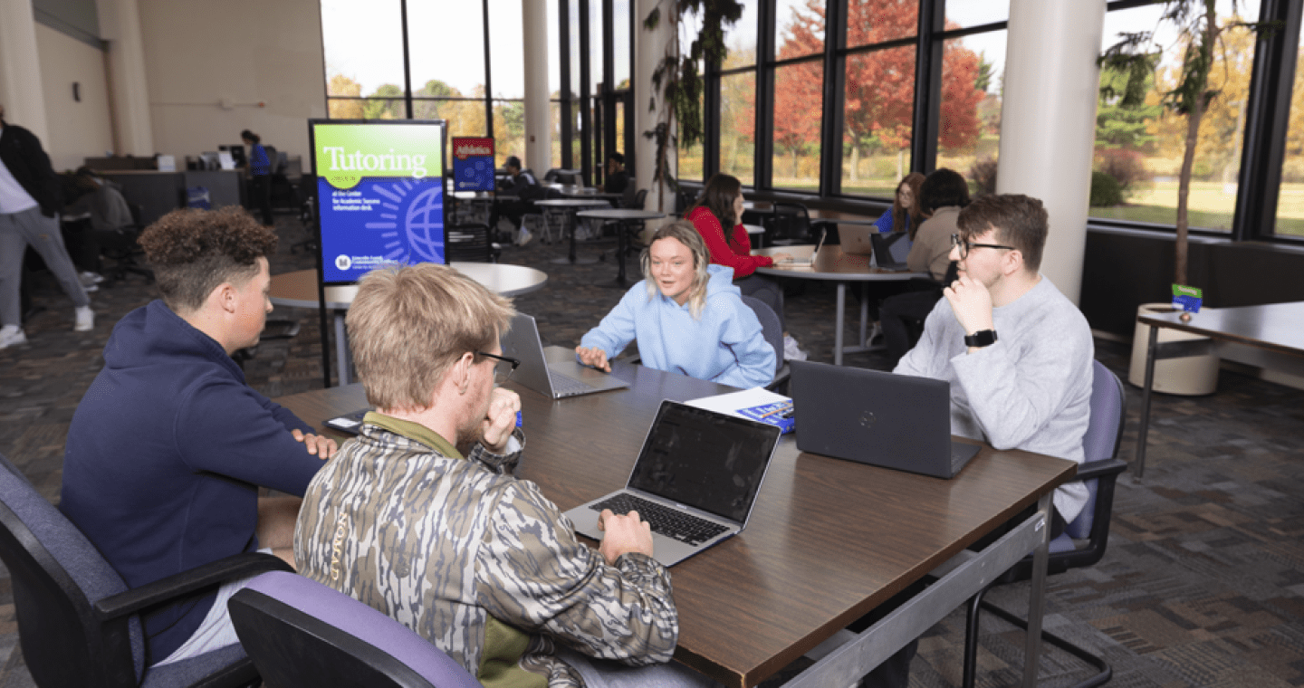 four students at a table in the LLCC Writing Center