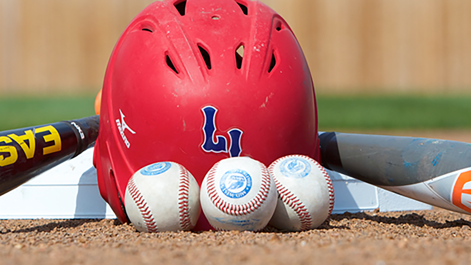 An LLCC baseball helmet with two baseball bats and three baseballs