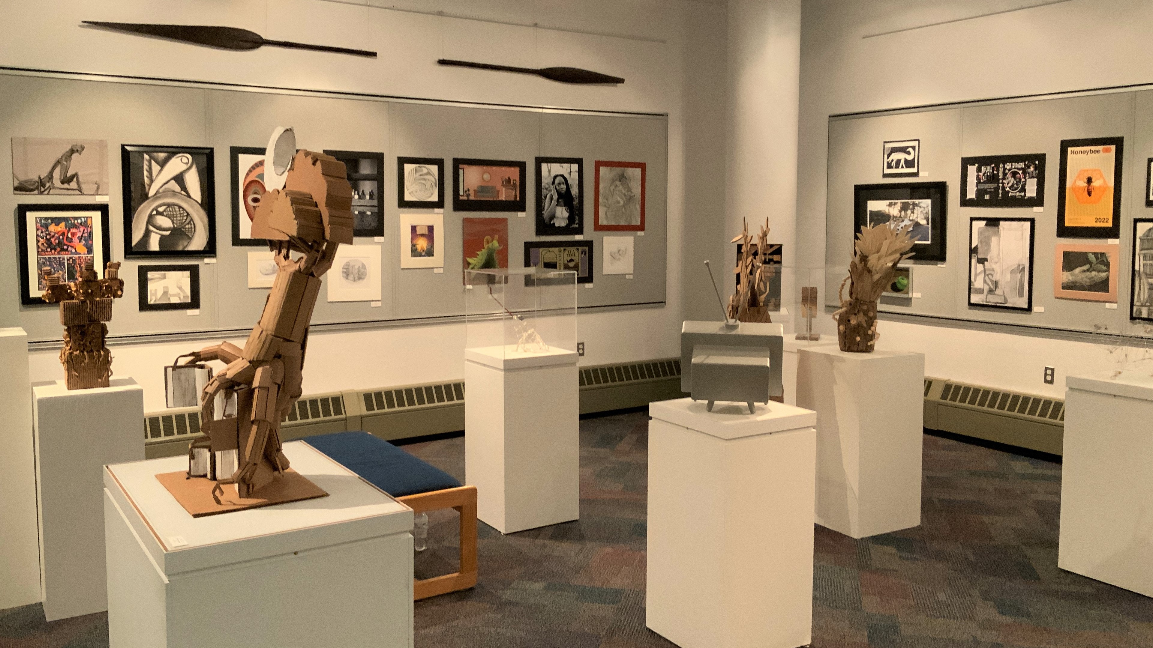 The inside of the James S. Murray Gallery shows students art pieces displayed on pedestals and on the walls.
