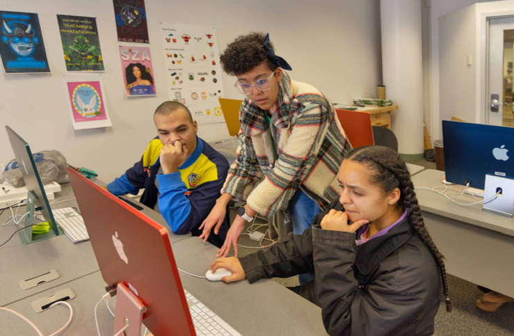 Three students working together in Mac lab