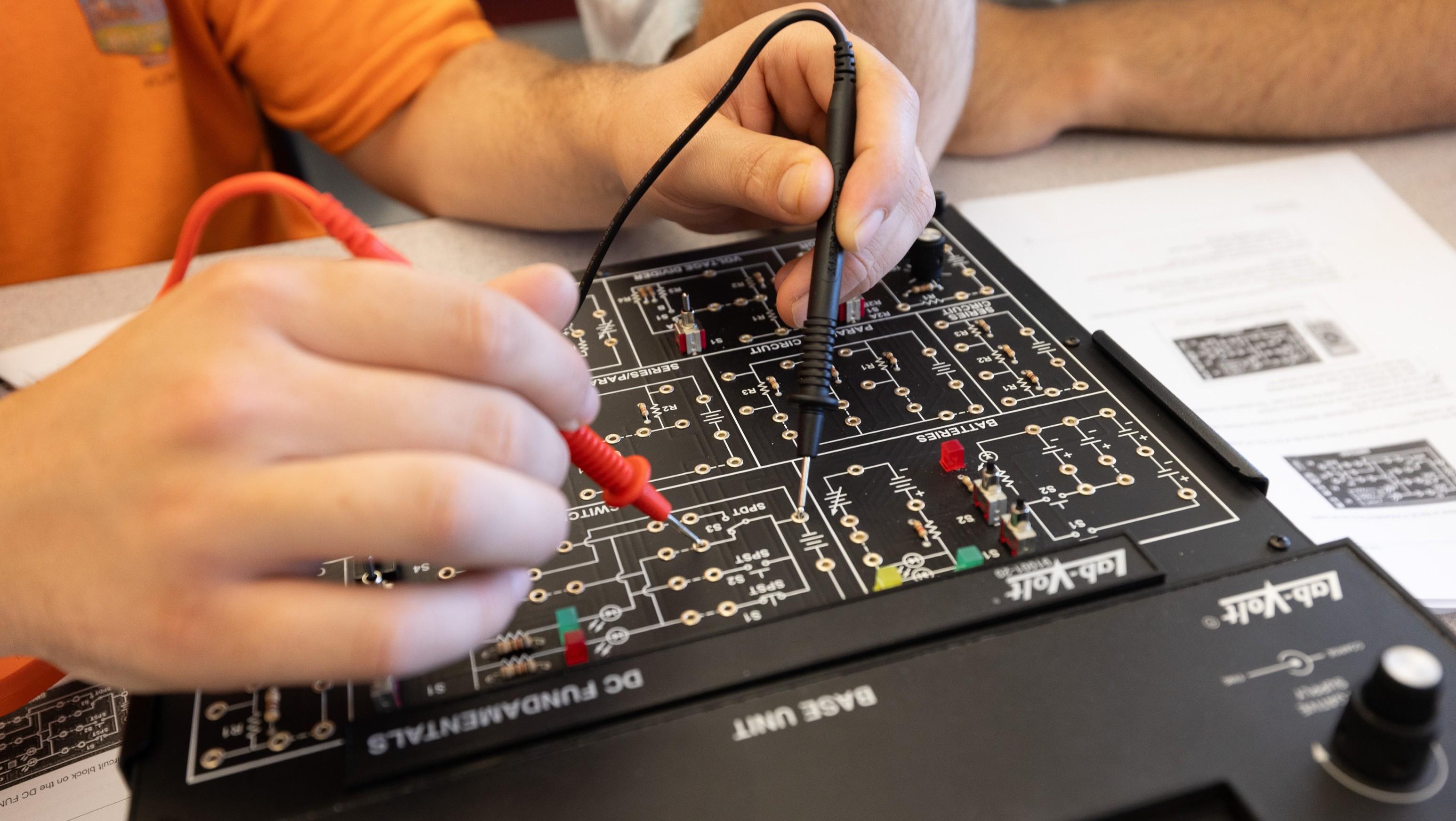 Person working on a circuit board