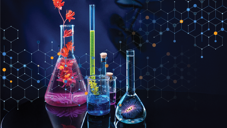 Glass lab flasks and cylinders with colorful liquids and flowers, set against a dark background with hexagonal molecular patterns.
