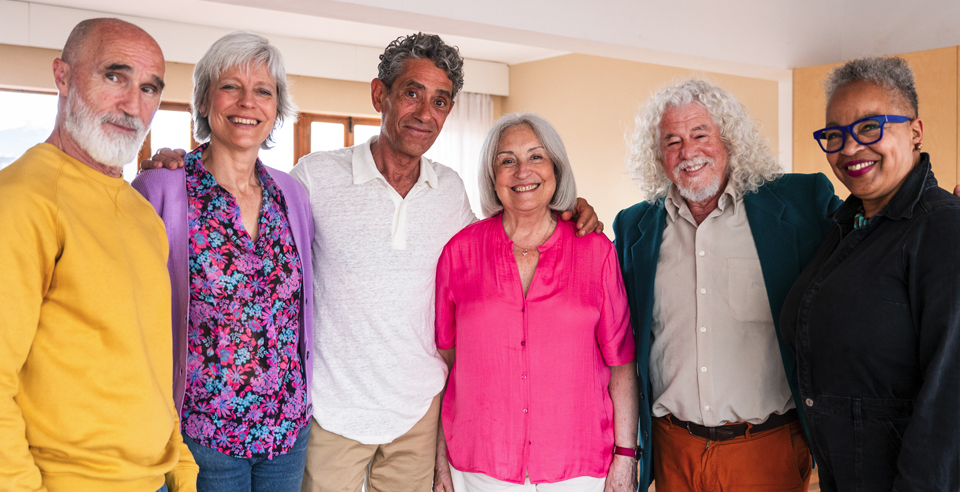 diverse group of smiling 50+ adults