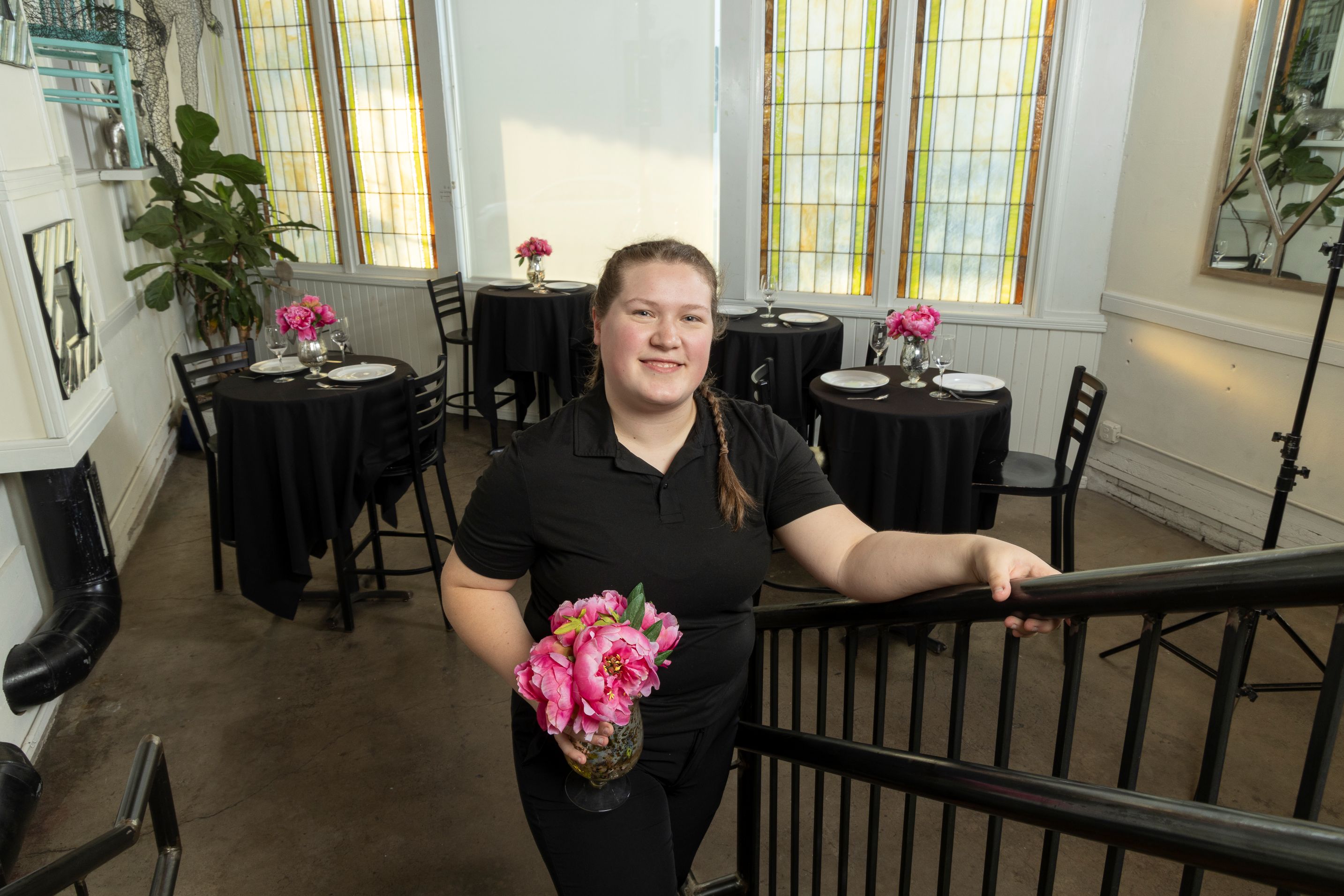 Ella Schuerer holding a vase of flowers