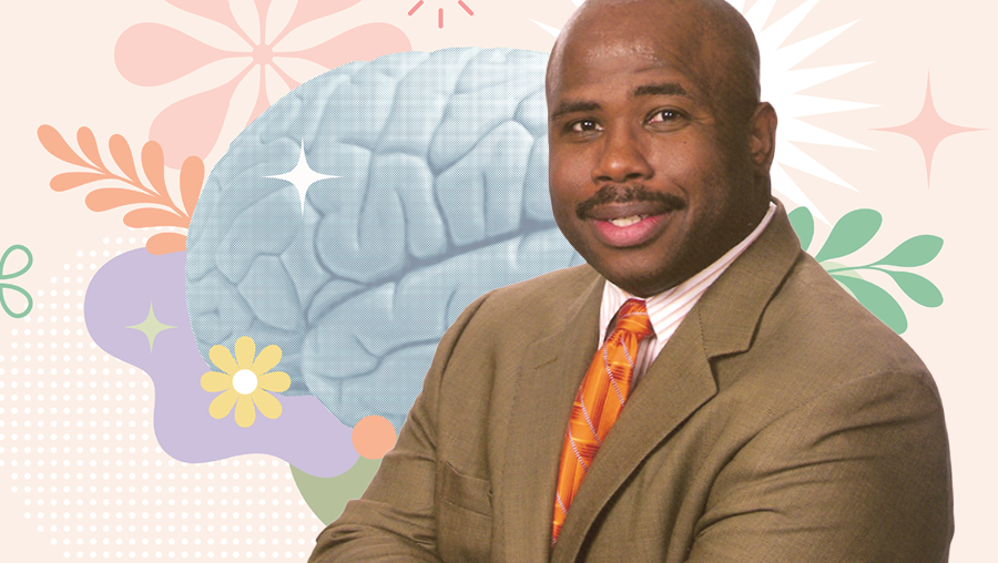 Person in brown suit with orange tie, arms crossed, against a pastel background with an illustrated brain and floral shapes.
