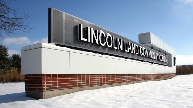 The Lincoln Land Community College entrance sign shown in winter with snow on the ground.