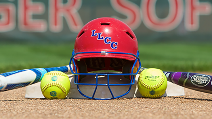 An LLCC softball helmet with two softball bats and two softballs