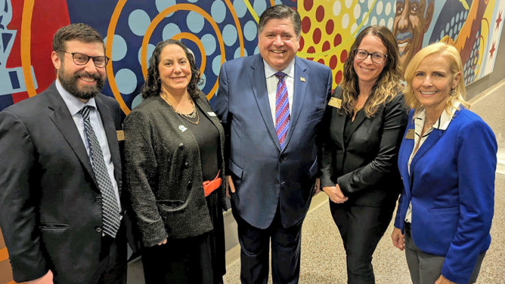 Four LLCC staff members with IL Governor J.B. Pritzker