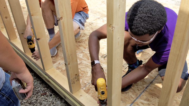 High school student working in a construction environment.