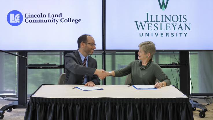 Dr. Dockter and Dr. Georgia Nugent signing the admission agreement while sitting at a table.