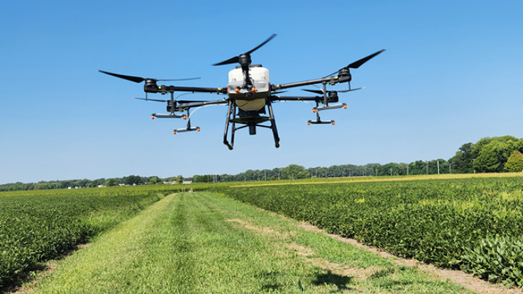 Large drone flying over a field