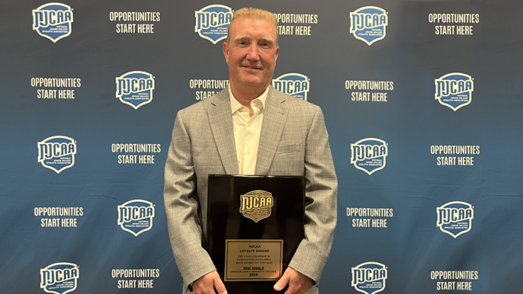 Ron Riggle with an award plaque.