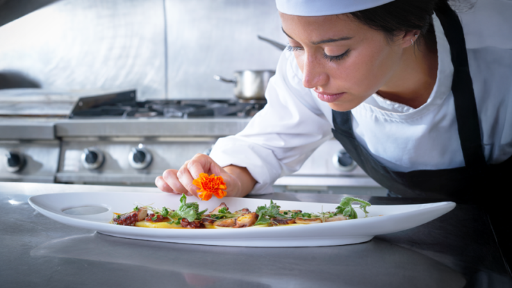 A chef examines their culinary creation.