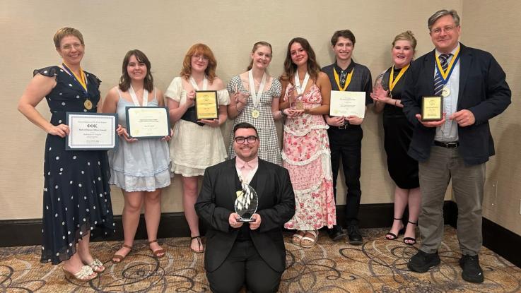 Seven PTK members and two advisors holding certificates