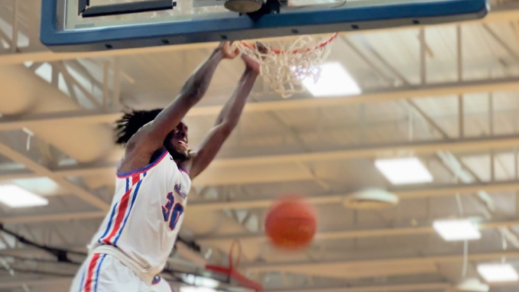 male basketball player dunking a ball