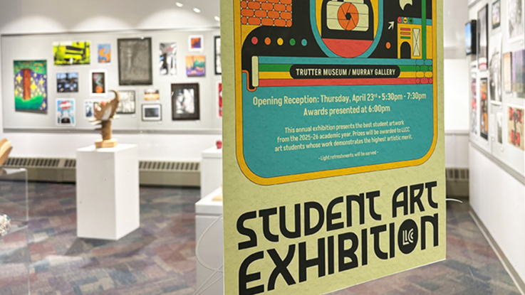 Colorful “Student Art Exhibition” poster in the foreground, with framed student artwork and sculptures displayed in a bright gallery behind it.