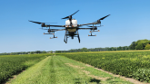 Large drone flying over a field