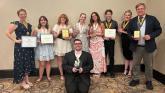 Seven PTK members and two advisors holding certificates
