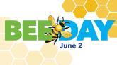A honeybee and hive with the text Bee Day, June 2