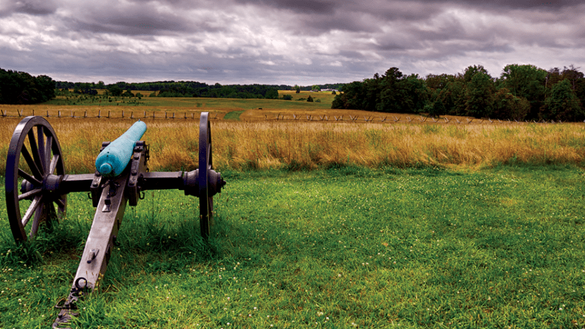 Picturesque scene of a cannon outside on the outskirts of a field