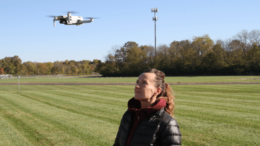 man holding controls of a drone