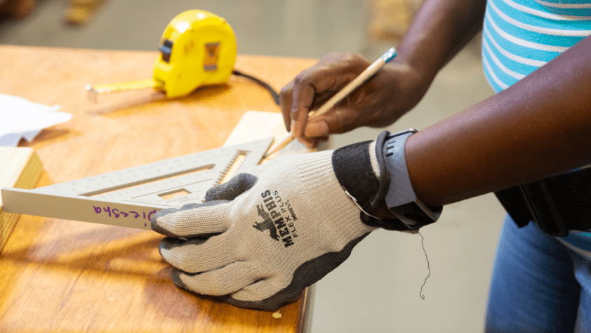 A closeup of a person's hands while measuring.