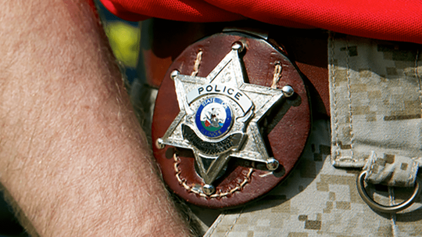 police badge on persons waist