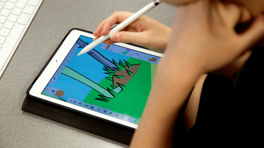student drawing on electronic tablet