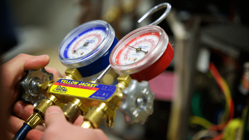 Close up of a person's hands as they hold a gauge.