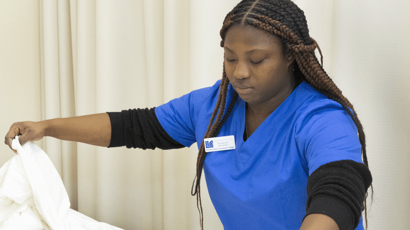 student washing patients hand