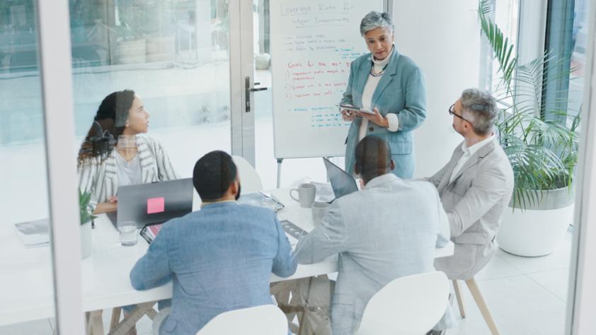 Five adults at a business meeting