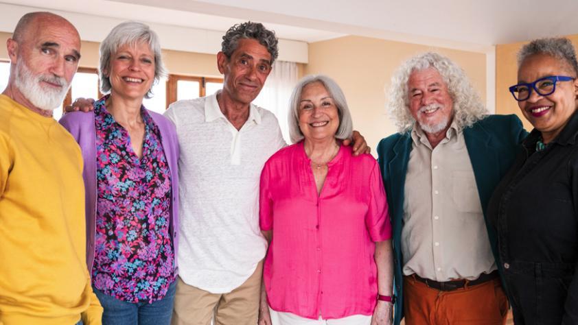 diverse group of smiling 50+ adults