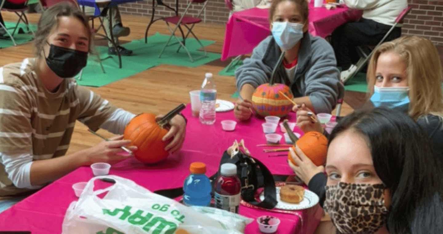 Students painting pumpkins 