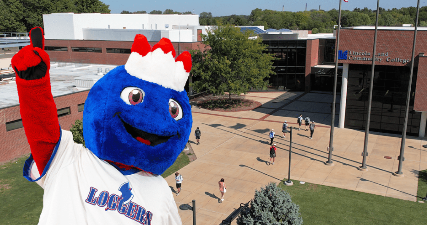 LLCC's mascot, Linc, in Loggers jersey holding up index fingers with an aerial photo of campus in the background