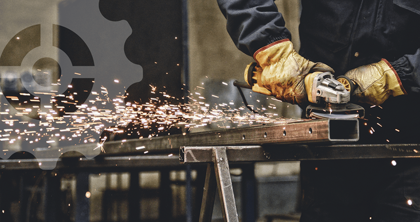 Hands running a grinder and sparks flying.