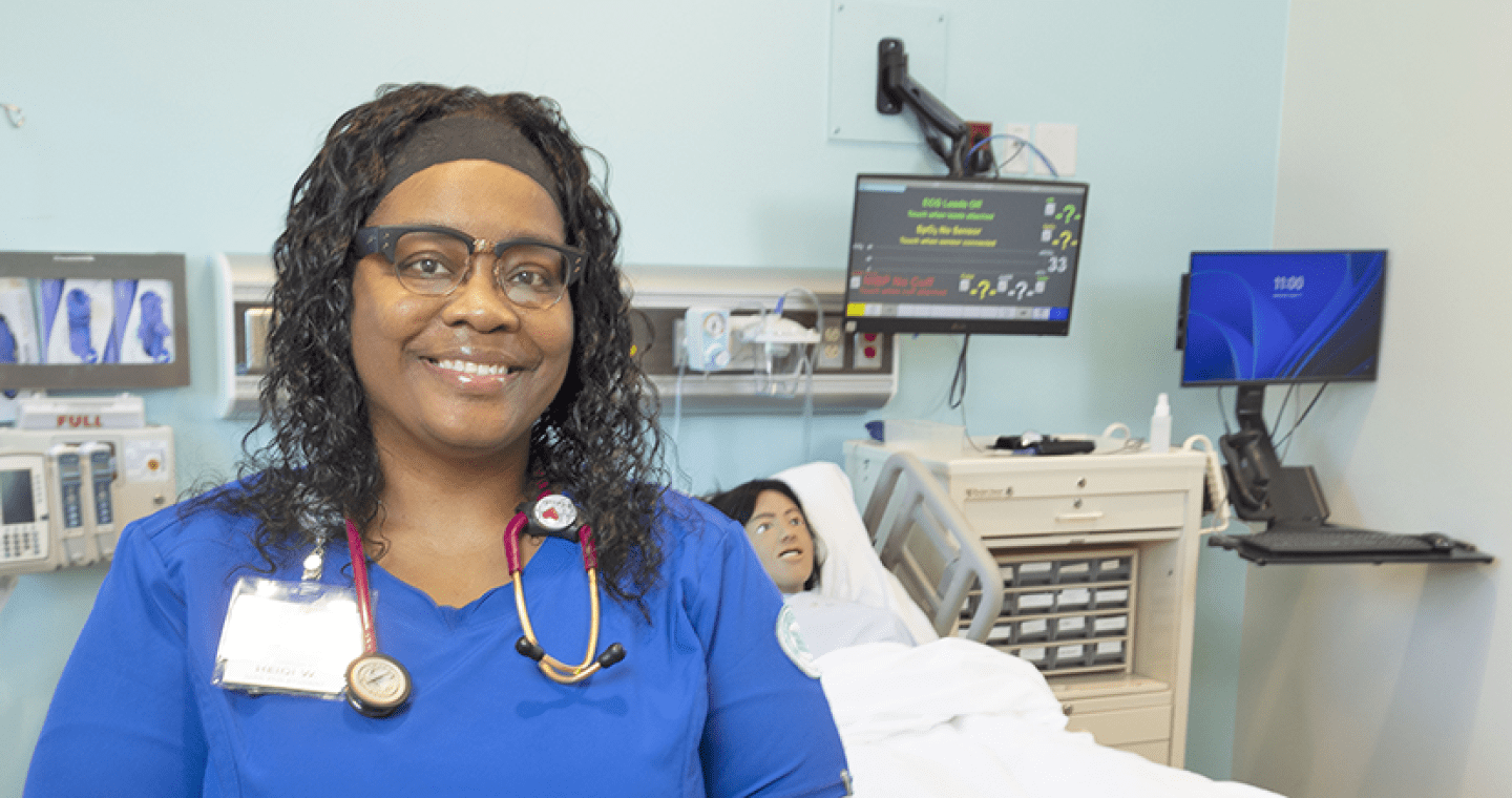 LLCC nursing student in blue scrubs.
