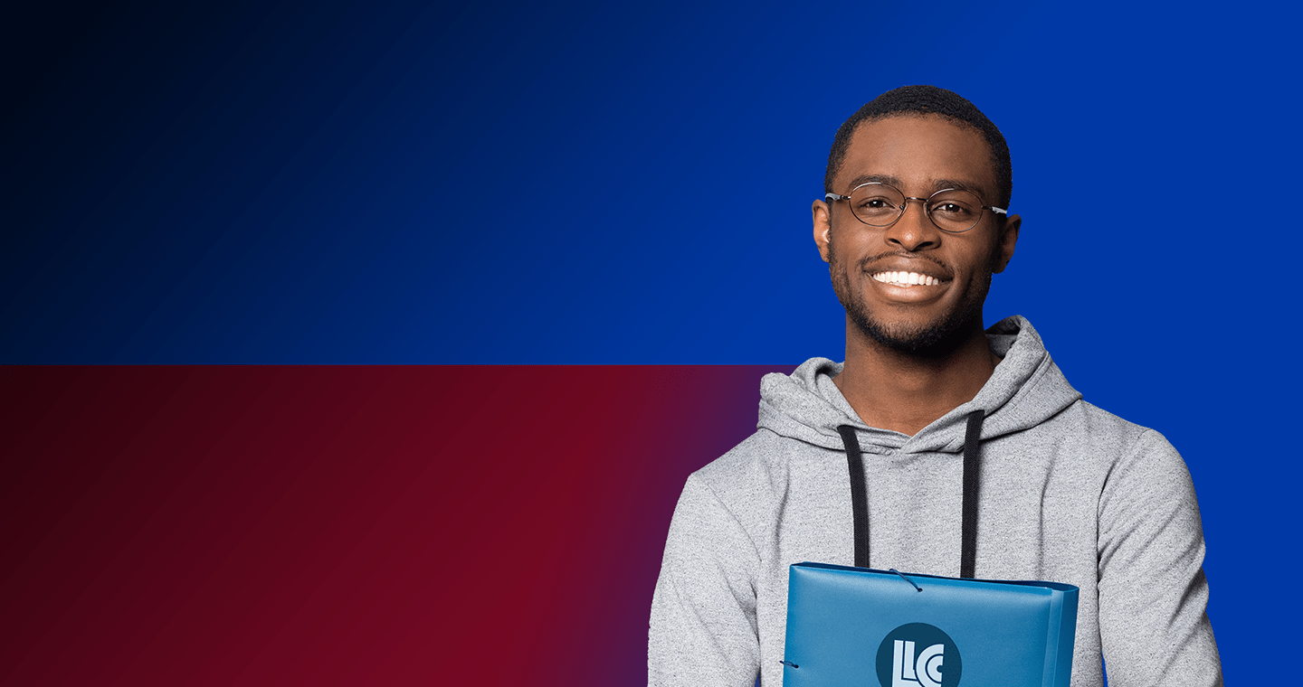 smiling student holding laptop