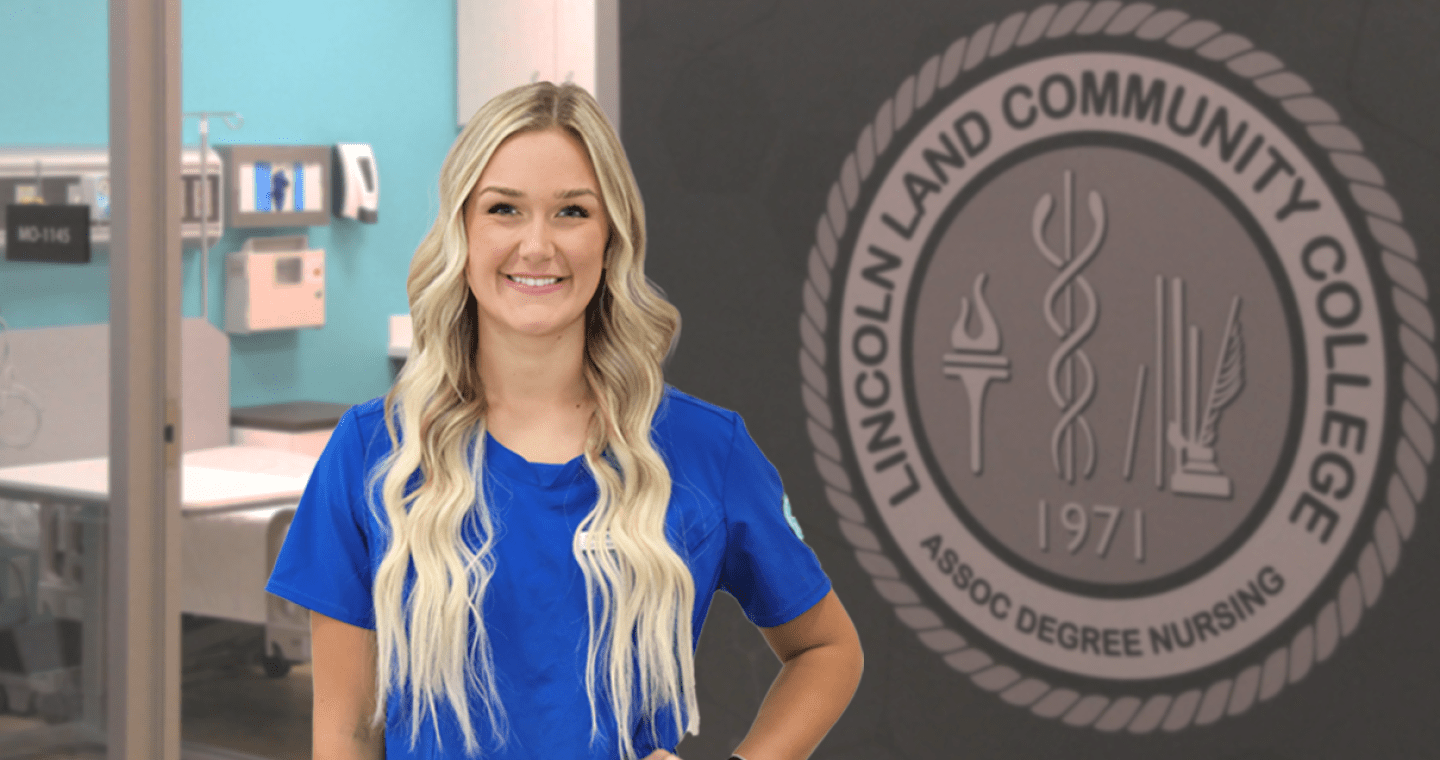 Nursing student poses in her blue scrubs near the nursing simulation lab.