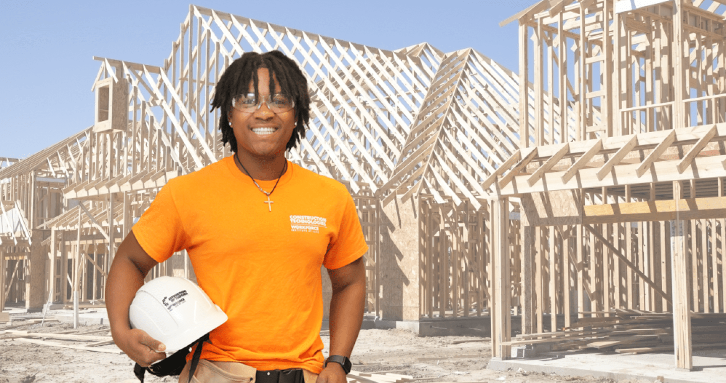 Construction Technology student poses with his hard hat.