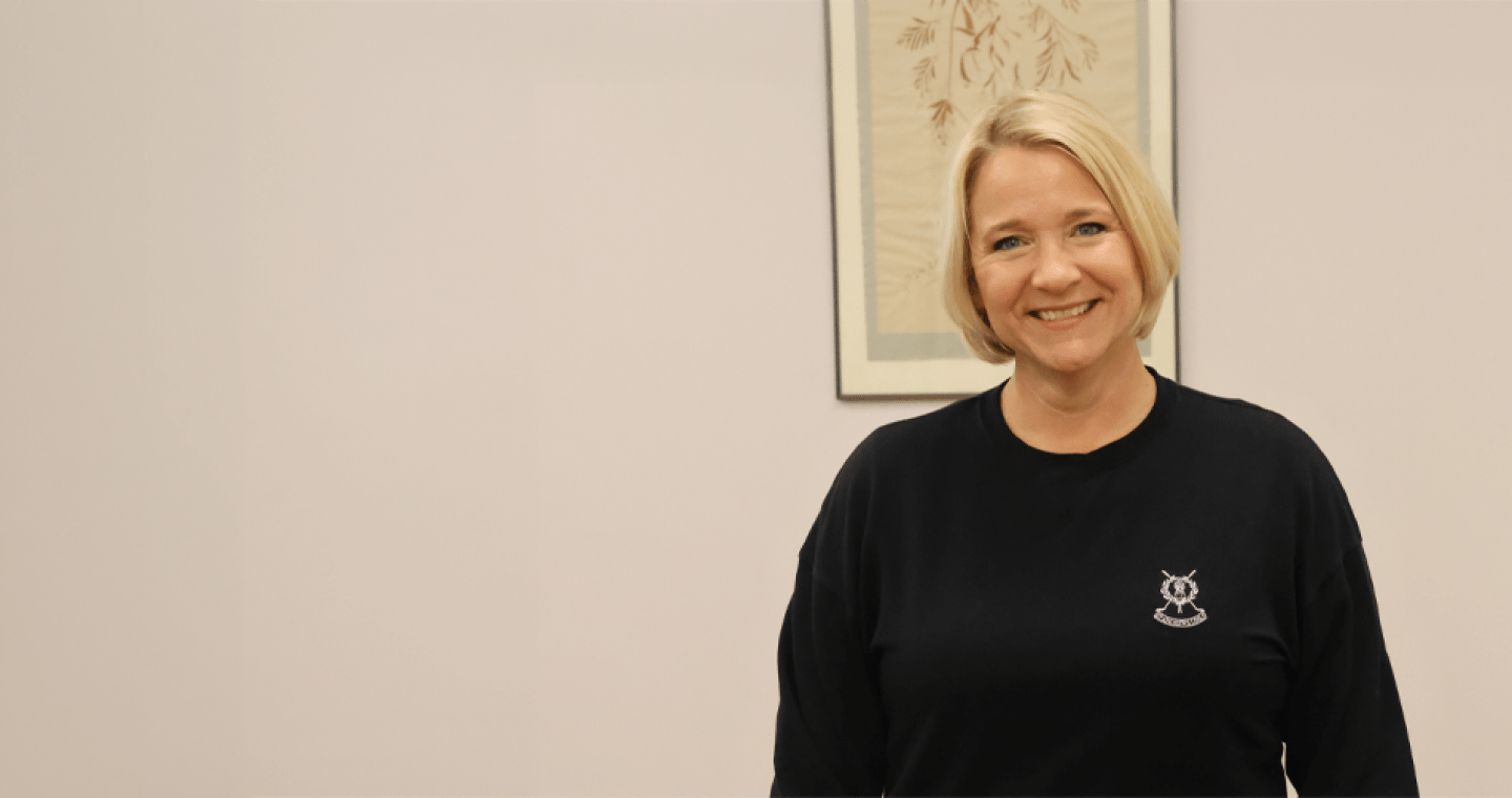 A woman with blonde hair smiling at the camera