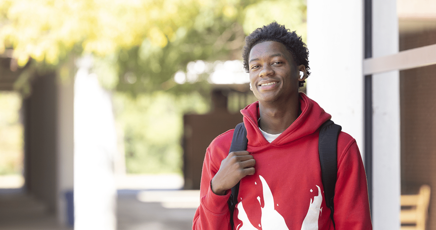 Student wearing backpack outside A. Lincoln Commons
