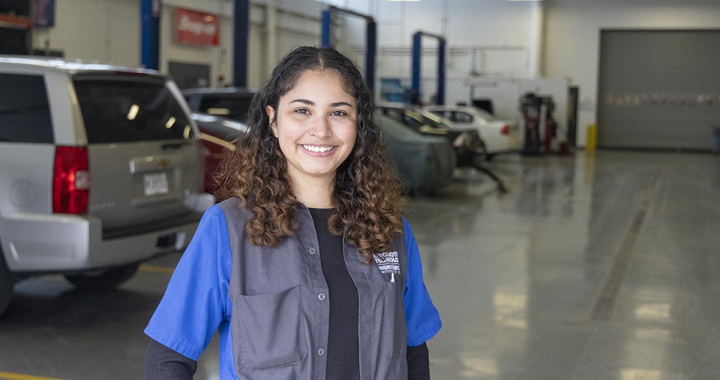 Female standing in an automotive workshop