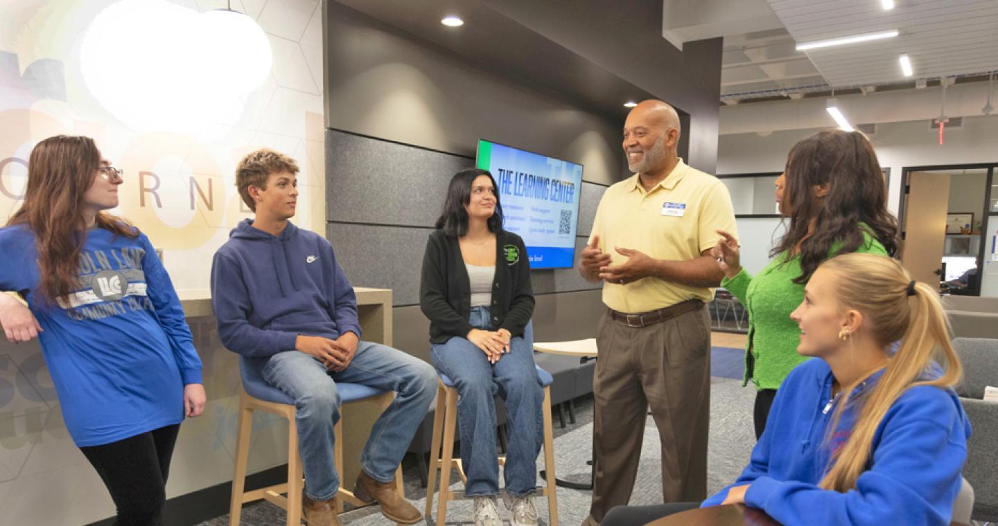 LLCC student success advisor talking to a group of students