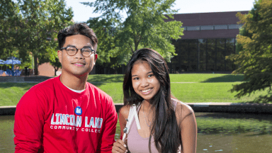 Two LLCC students by lake on campus