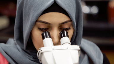 Student looking through microsope