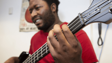 Student playing bass guitar