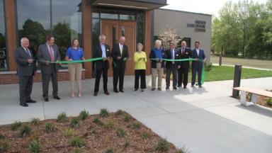Board and president cutting ribbon for Kreher Agriculture Center